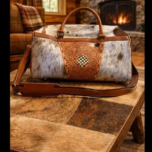 Spade Cowhide Duffle Bag with Intricate Tooled Leather Accents and Durable Brown Leather Straps