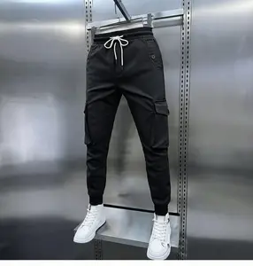 Men’s minimalist solid-color jogger cargo pants with a drawstring waist and button flap pockets; men’s work pants, jogging pants