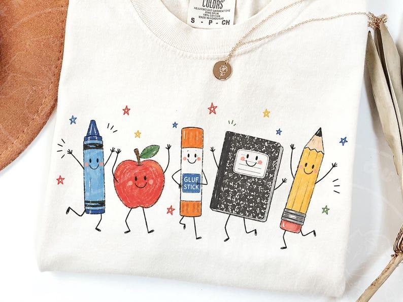 Comfort Colors Cute School Supplies Heritage Graphic Tee, Aesthetic Back To School Spirit Shirt, Radiant Teacher Crayon Apple Pencil Notebook Top, Thoughtful Classroom Sublimation Gift Boutique Heritage Apparel Comfort Colors Cute School Supplies Heritage Graphic Tee, Aesthetic Back To School Spirit Shirt, Radiant Teacher Crayon Apple Pencil Notebook Top, Thoughtful Classroom Sublimation Gift Boutique Heritage Apparel