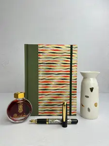 A5 160-page Hardcover Journal finished in olive green Japanese book cloth and gold, black and red geometric Chiyogami Paper