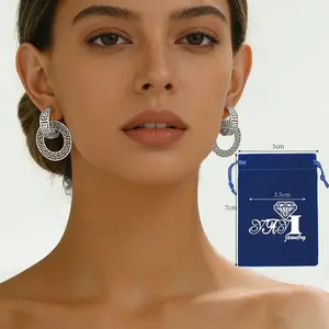 A pair of Greek style silver patterned circular earrings with retro hollow out design, designed to enhance face shape, suitable for wearing at parties and festivals.