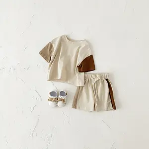Two-piece baby outfit with a patchwork design featuring a loose short-sleeve top and comfortable, breathable shorts for infants and toddlers (short-sleeve and shorts only, no shoes, hats, or other accessories included).