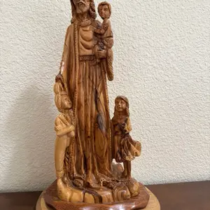 This item is a hand-carved olive wood statue depicting the scene "Jesus with the Children," a popular Christian artwork crafted in Bethlehem