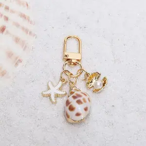 1pc Asymmetrical Shell, Starfish, and Sea Snail Wallet Pendant Keychain, Stylish Nautical Decor for Bags, Unique Ocean-Inspired Accessory