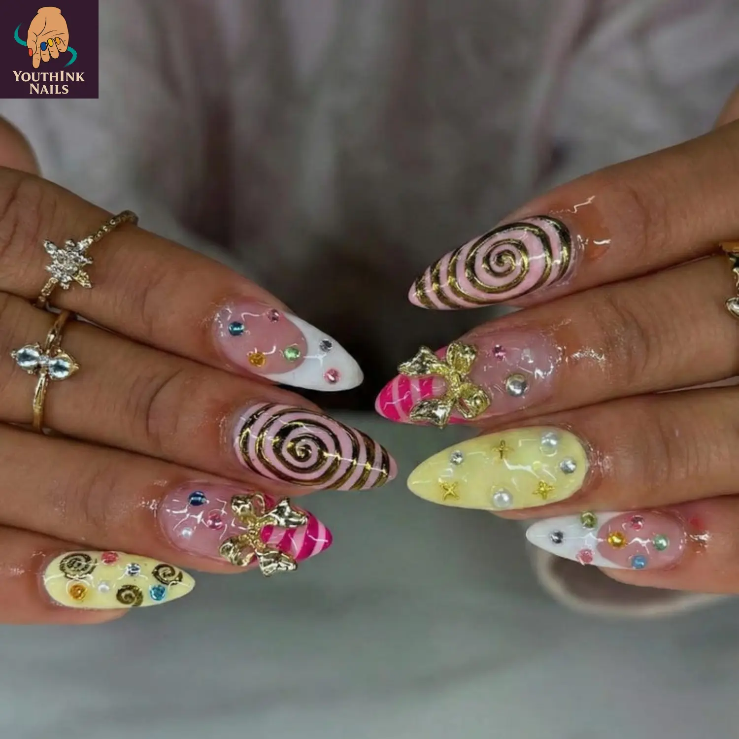 Candy Swirl Pink Yellow Press On Nails, handmade 3D gel nail art with spiral lines, bow charms, pearl rhinestones, colorful sweet aesthetic, reusable press on nails for party, birthday, photoshoot, cute Y2K statement look
