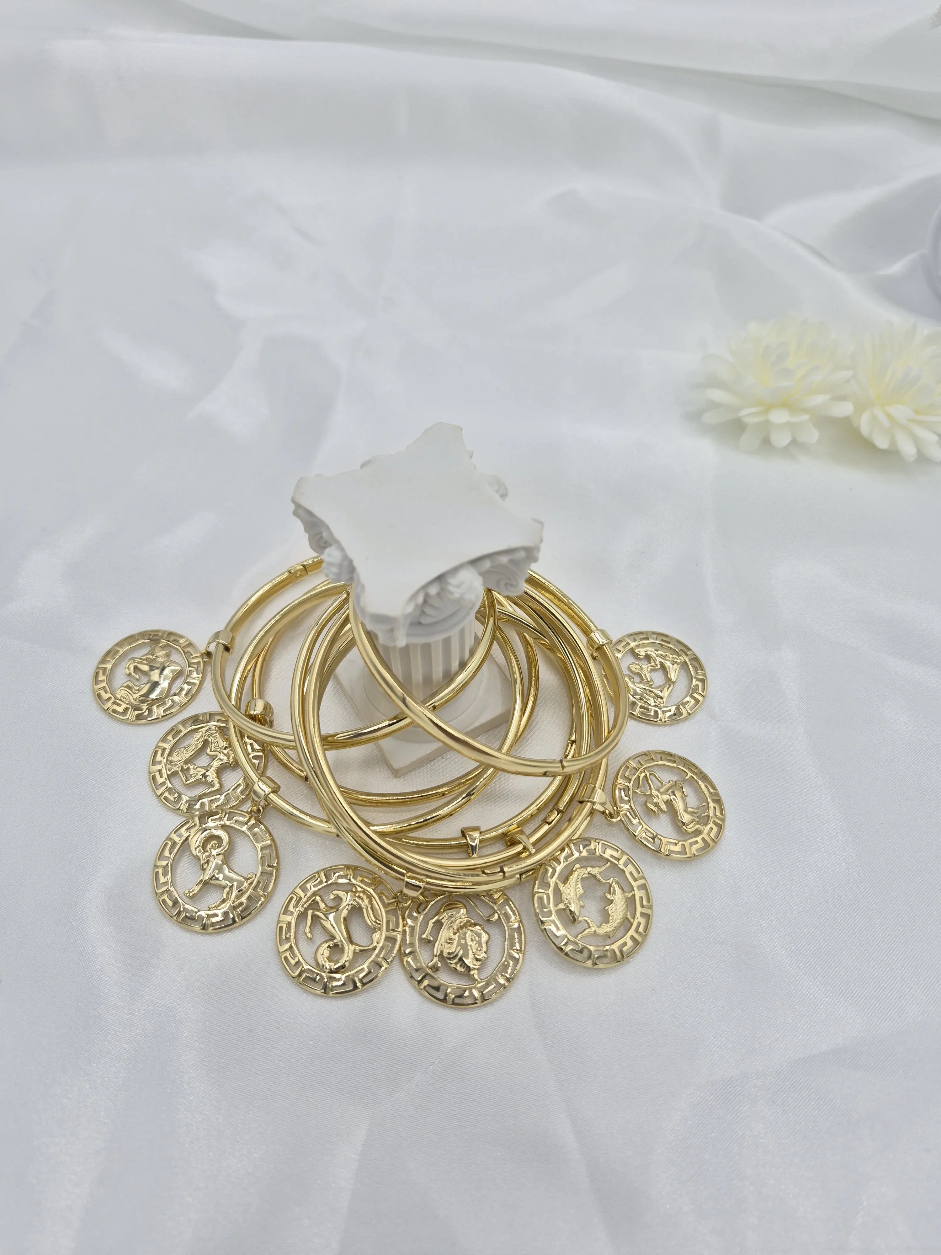 Bangle bracelet with zodiac sign charm, 14k gold plated. (62)