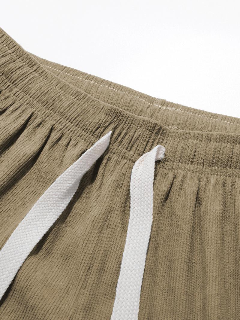 Two men's autumn casual pants featuring a simple and versatile style with drawstring design, adding a casual feel. The pants have delicate small details, such as stitching accents, making them comfortable and stylish. The loose fit provides comfort and fr