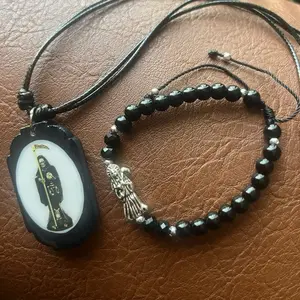 Black Santa Muerte necklace and bracelet unisex matching set. Adjustable sizes on both.