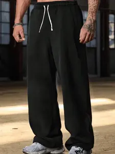 Men’s plus-size gray wide-leg sweatpants with tribal motif print; trendy casual joggers with a European/American style; loose fit available in multiple colors; drawstring design; comfortable and versatile.