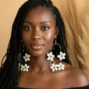 31/ KANDY-FLOWERS: Afrocentric handmade natural cowries designs earrings.These earrings are crafted by West African artisans. They showcase and celebrate beauty and heritage.