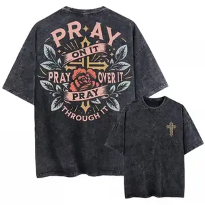 Unisex Vintage Washed Oversized Black T-Shirt with Short Sleeves, Featuring Graphic Designs for Both Men And Women. The Clothing Emphasizes Themes of Prayer with Phrases Like 'Pray on It, Pray Over It