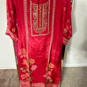 Red Crepe Suit Printed and Embroidered with Floral Motifs and Gold Accents for Festive Wear