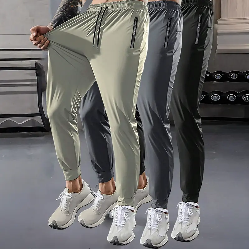 Men’s quick-dry breathable jogger pants with zippered pockets, lightweight design, drawstring waist, stretchy fabric, casual athletic style, plus size fit, suitable for running, fitness, training, and spring wear.
