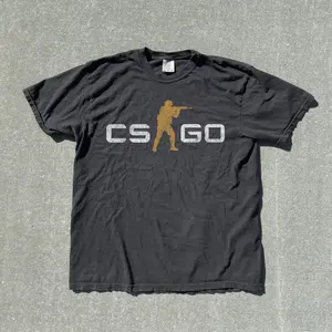 CS GO Tactical Shooter Vintage T-Shirt, Gold Soldier Silhouette Logo Graphic Tee, Retro Y2K Grunge Streetwear Comfort, Counter Strike Shirt, Gamer Gift