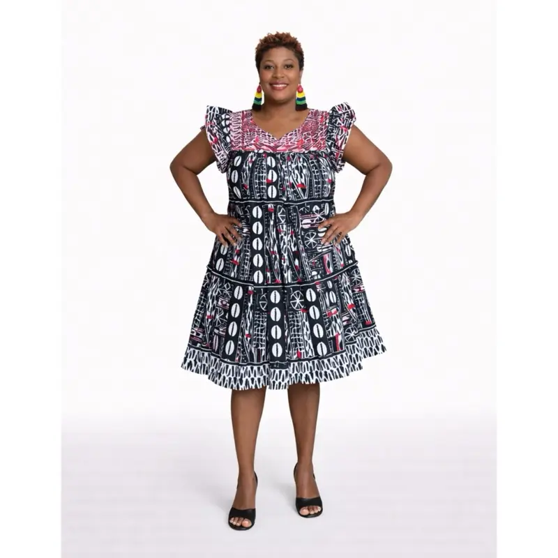 Bold and elegant African print dress featuring a mix of black, white, and red patterns. Ruffled Bold and elegant African print dress featuring a mix of black, white, and red patterns. Ruffled