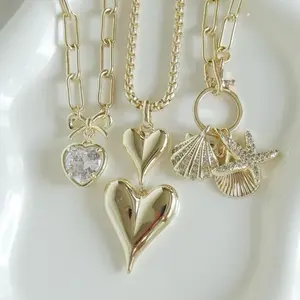 Shop The Look- 14k Gold Plated Double Heart Necklace, Bow Clear Heart Necklace and Seashell Starfish Charm Necklace