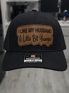 I Like My Husband a Little Bit Younger Leather Patch Trucker Hat – Funny Wife Humor Cap, Mesh Back Snapback, Playful Gift for Couples, Valentine Gift