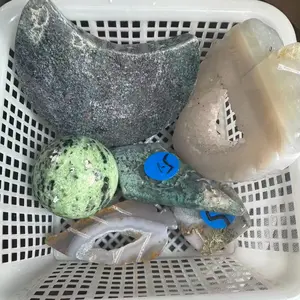 Red-green gemstone sphere and moon carving