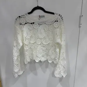 THALIAHandmade Crochet Knit Top – One Size Fits All XS to L – Elegant Bohemian Crochet Lace Blouse with Long Sleeves, Lightweight Knitwear Layering Top for Summer, Beach, Resort and Everyday Chic Styling  The THALI Handmade Crochet Knit Top is a beautiful