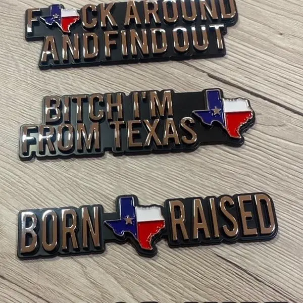 Texas Car Emblem - Black Background with Texas Flag Design, Featuring "FUCK AROUND AND FIND OUT" and "BORN RAISED" Text.