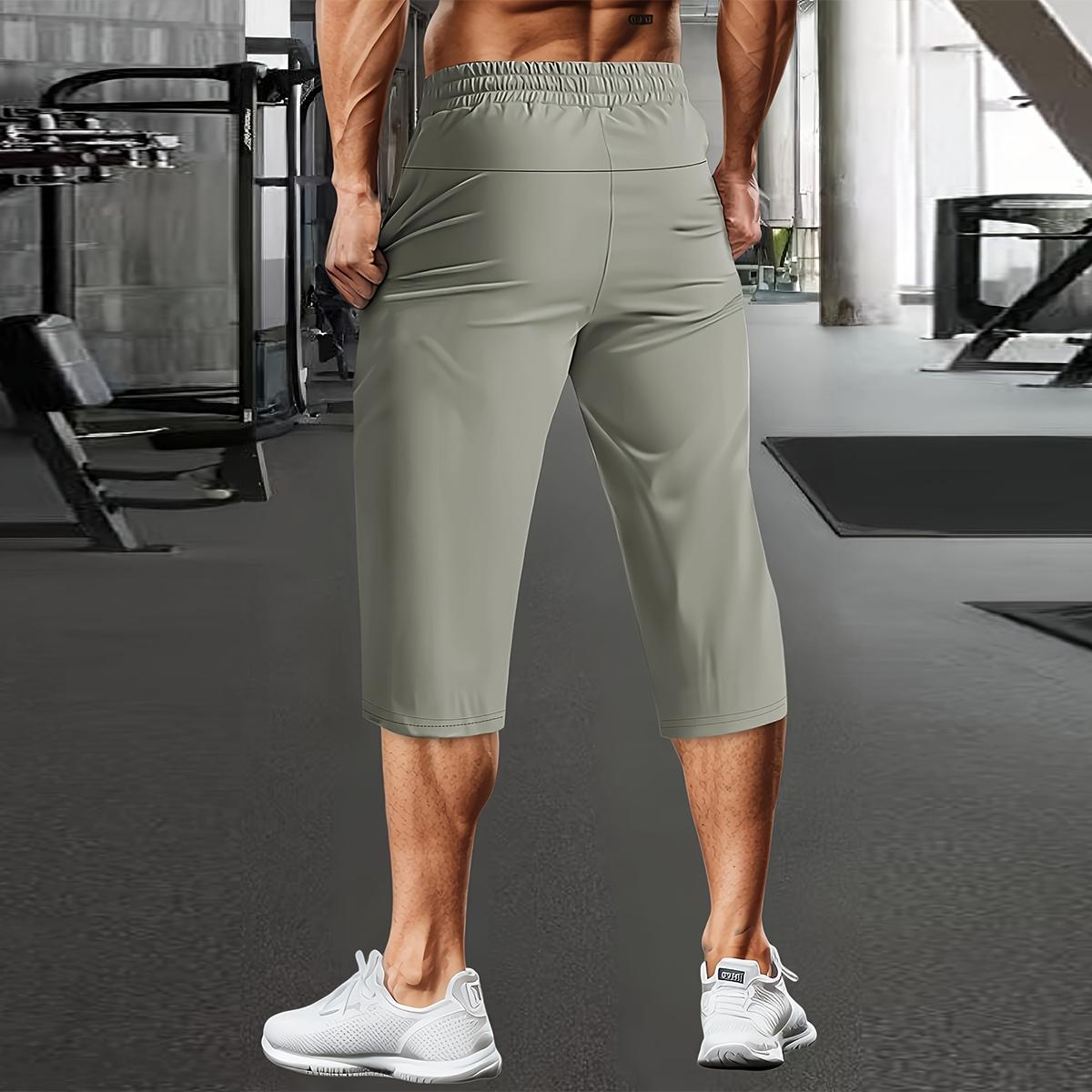 Men's casual stretchable ice silk fabric breathable waist drawstring, zipper pocket fashion sports capri pants with reflective print. Basic comfortable quick-drying breathable outdoor running, cycling, training and sports capri pants.