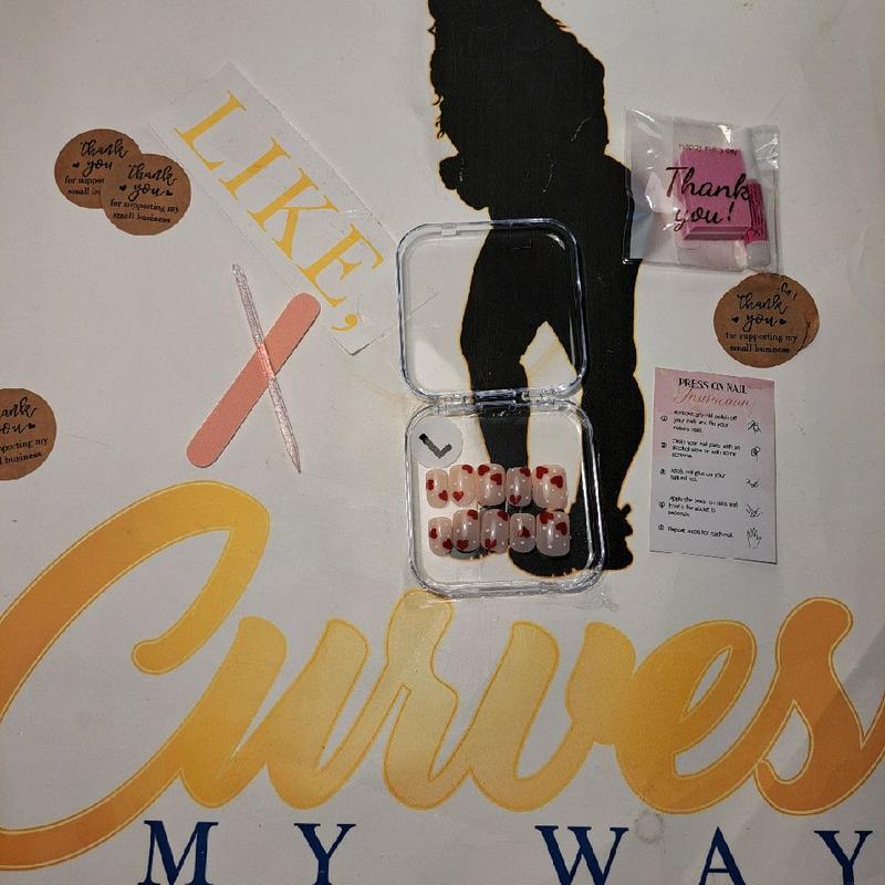 CMW (Dots of Love) press-on nails bring a playful romance to your fingertips. Featuring a nude natural base adorned with white polka dots and red hearts, these short square nails offer a classic yet fun look—exclusively in a size medium only."