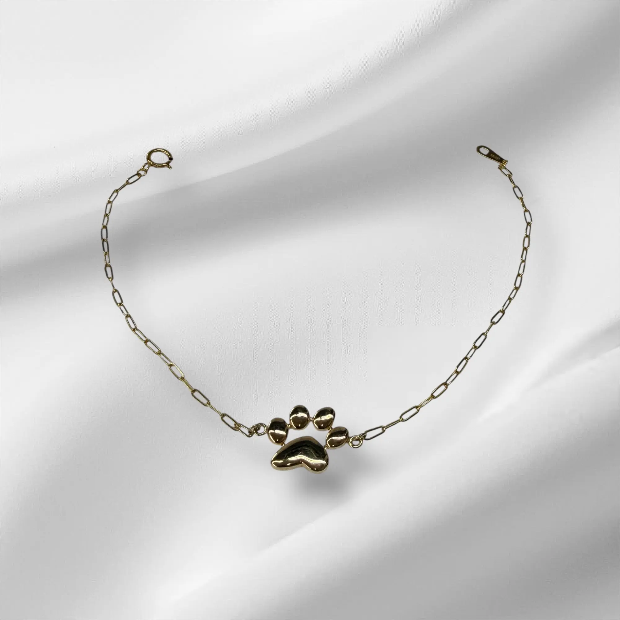 Esclava paperclirp con huella de perrito 7.25” oro 14k