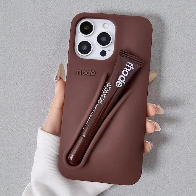 Rhode Lip Tint Silicone Phone Case with Lip Gloss Holder for iPhone 11-17 Shockproof Design Smooth Application Fashionable Protective Nutrients Convenient Daily Use