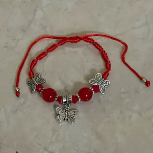 This red butterfly bracelet is very cute