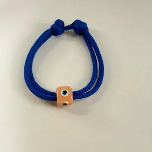 Adjustable blue cord with big evil eye