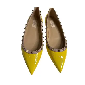 Valentino Garavani Rockstud Patent Leather Ballet Flats in Yellow.