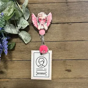 Valentine-themed badge reel with a pink angel, pom-pom accent, and heart charm. Lightweight, fun, and full of love.