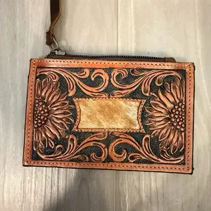 Pouch wallet with tooling and cowhide