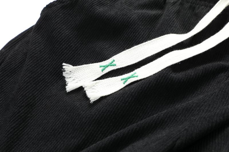 Two men's casual pants featuring a simple and versatile style with drawstring design, adding a casual feel. The pants have delicate small details, making them full of texture. The loose fit provides comfortable and relaxed wear, suitable for everyday outi