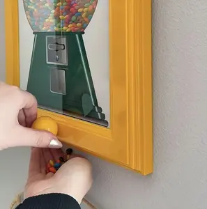 A Square Photo Frame Designed To Be Hung On The Wall, Featuring A Built-In Candy Dispenser—Perfect For Displaying Photos While Making It Easy To Access Candies, Nuts, And Pet Snacks. A Stylish And Functional Home Decor Accessory.