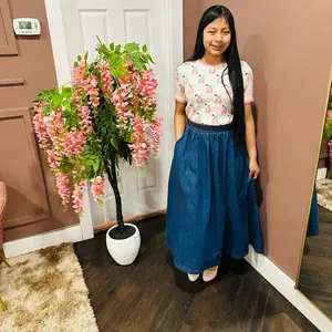 Middi skirt denim Womenswear This is a long, dark blue denim skirt.