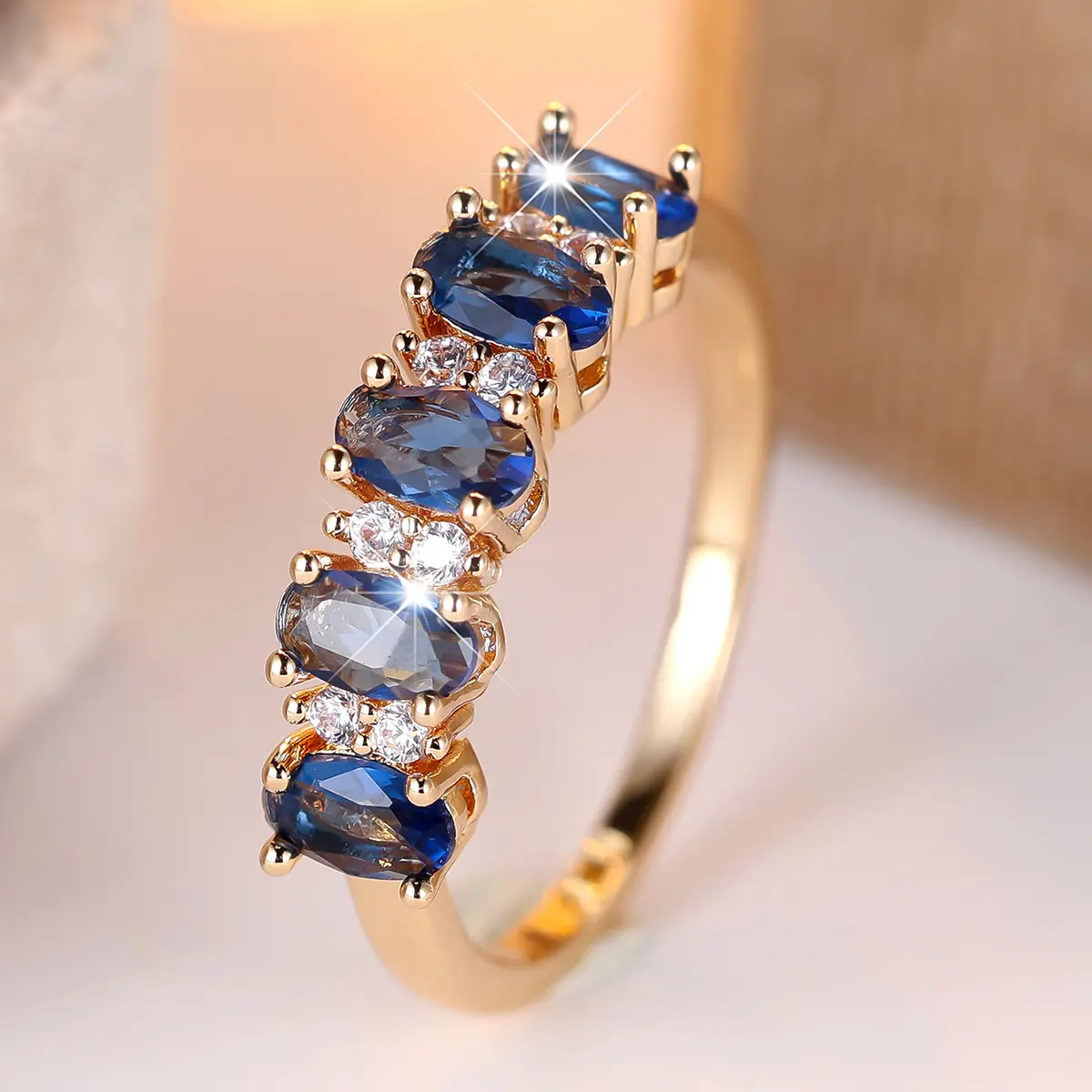 A gold egg-shaped ring with a sapphire blue edge and white diamonds, made of synthetic blue zirconia, is suitable for women to wear daily at wedding parties, Party Rings, Statement Rings Gold