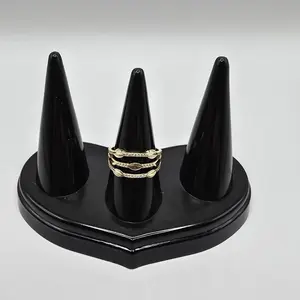 Delicate gold 14k band set featuring a layered design with polished leaf-shaped accents and fine clear, stones. Size 7