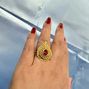 Gold tone finger ring with red stone for women