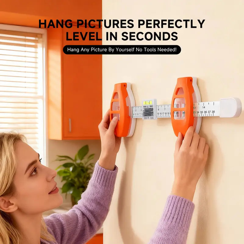 Picture hanging alignment tool being positioned on wall