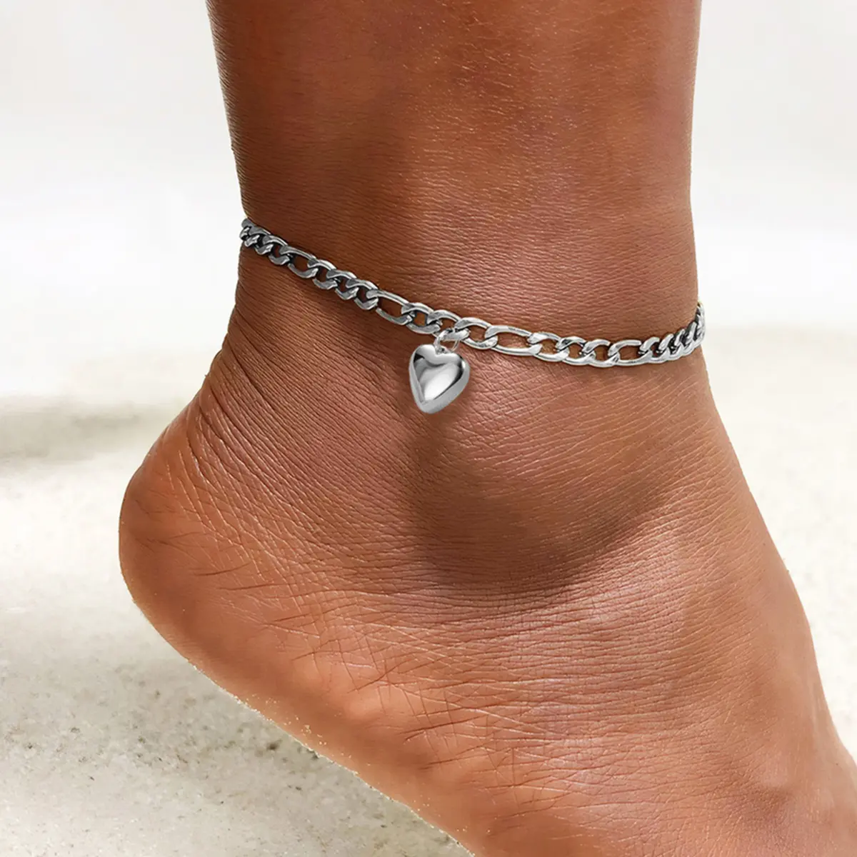 Minimalist silver heart-shaped stainless steel anklet for women—perfect for the beach and everyday wear