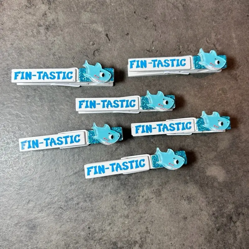 Cute Shark fin-tactic Sports Clips & cheer pins! Perfect for clipping and pinning backpacks at gymnastics or cheer competition, swim meet, softball or soccer game, volleyball or basketball tournament!