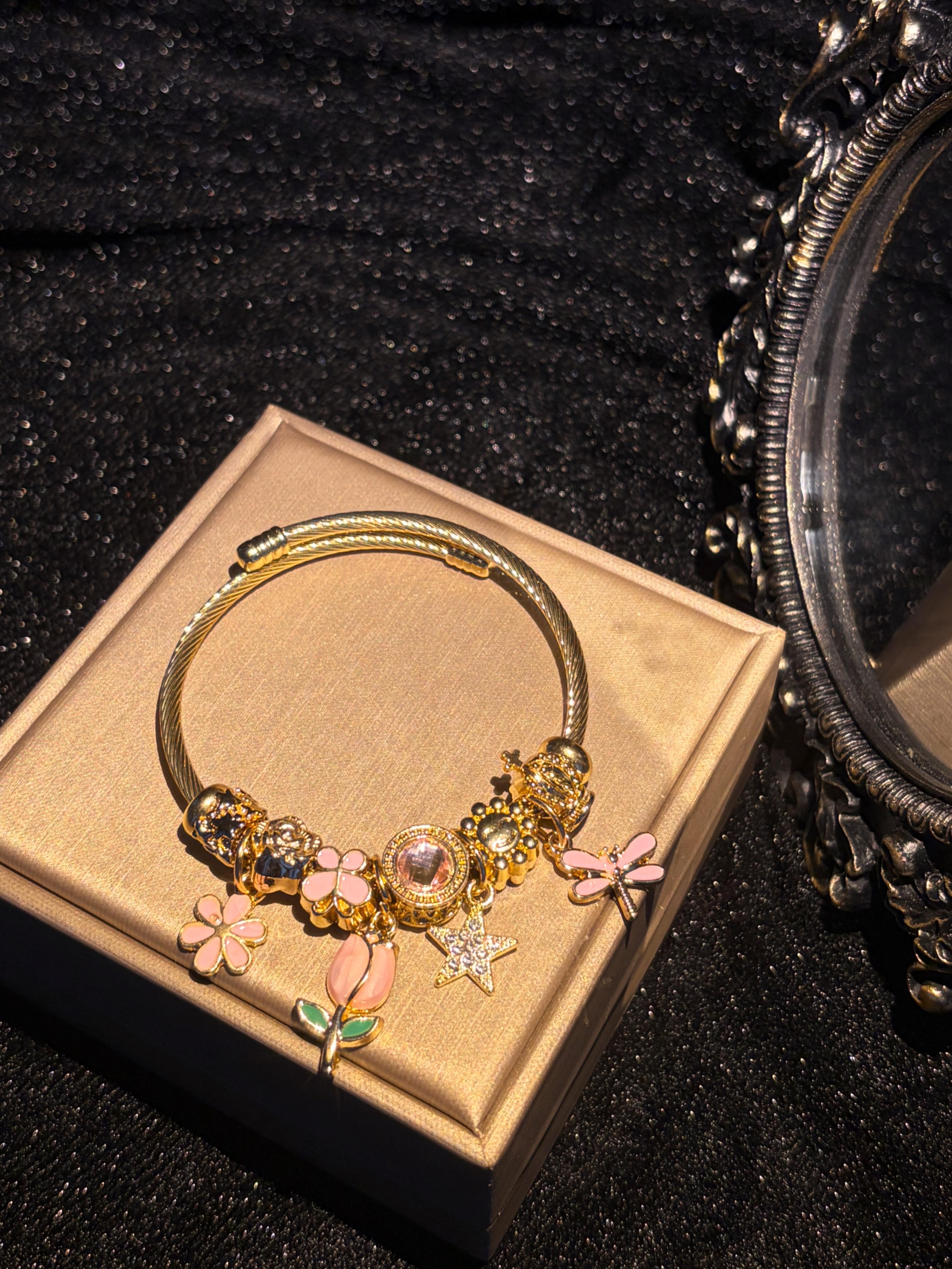 Women's Gold-Tone Open Bangle Bracelet with Pink Flower, Dragonfly, Star & Crown Charms, Stackable Costume Jewelry Gift