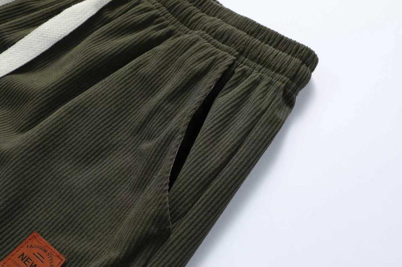 Two men's casual pants featuring a simple and versatile style with drawstring design, adding a casual feel. The pants have delicate small details, making them full of texture. The loose fit provides comfortable and relaxed wear, suitable for everyday outi