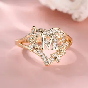 A heart-shaped initial ring in 14k gold plating, adorned with delicate Cubic Zirconia stones, featuring 26 letters of the alphabet (A-Z), with adjustable size for personalized name customization.