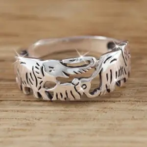 An elegant silver-plated ring with a family elephant design, suitable for women to wear daily, as a gift, or to parties.