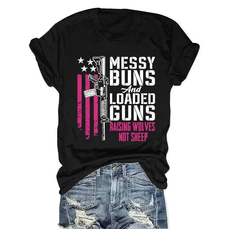 Women's Patriotic "Messy Buns & Loaded Guns" Graphic T-Shirt - American Flag & Rifle Design, Raising Wolves Not Sheep Slogan, Black with Pink/White Lettering, Casual Crew Neck Short Sleeve Top, Machine Washable, Crewneck Womenswear