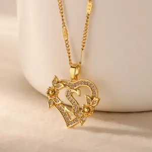 An elegant 18k gold-plated necklace with a heart-shaped and flower-shaped pendant adorned with Zirconia stones, featuring 26 initial letters, perfect for everyday wear and as a gift for women.
