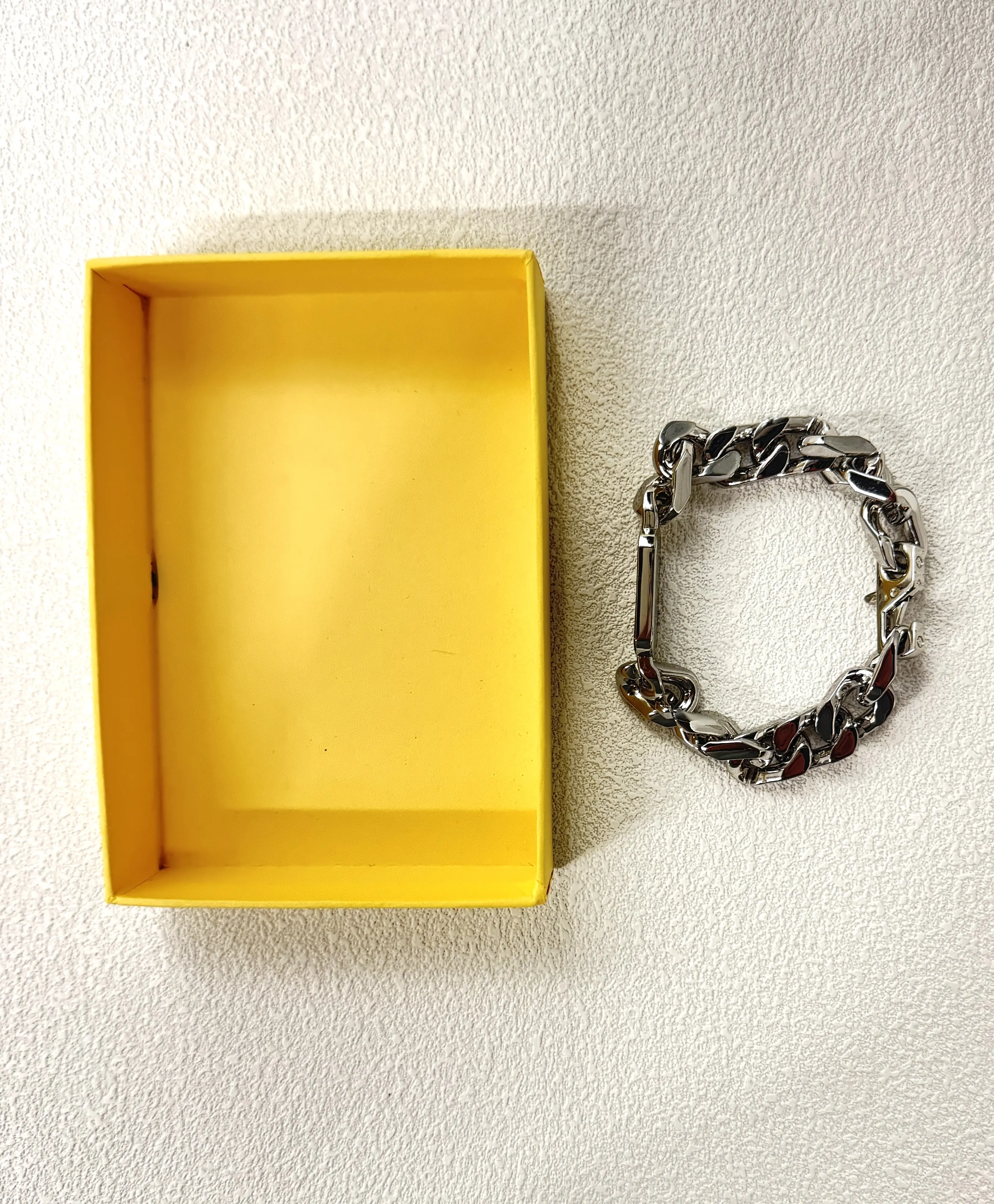 An engraved bar on a 20cm chain—fixed length, intentional fit. For her, for him, for stacking.