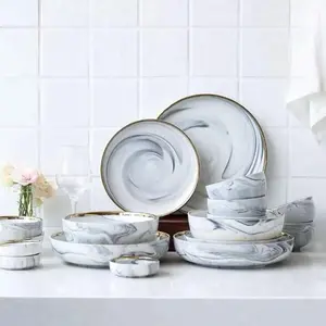 Luxury Dinnerware Set with Gold Trimmed Plates and Matching Utensils for Elegant Dining Experience